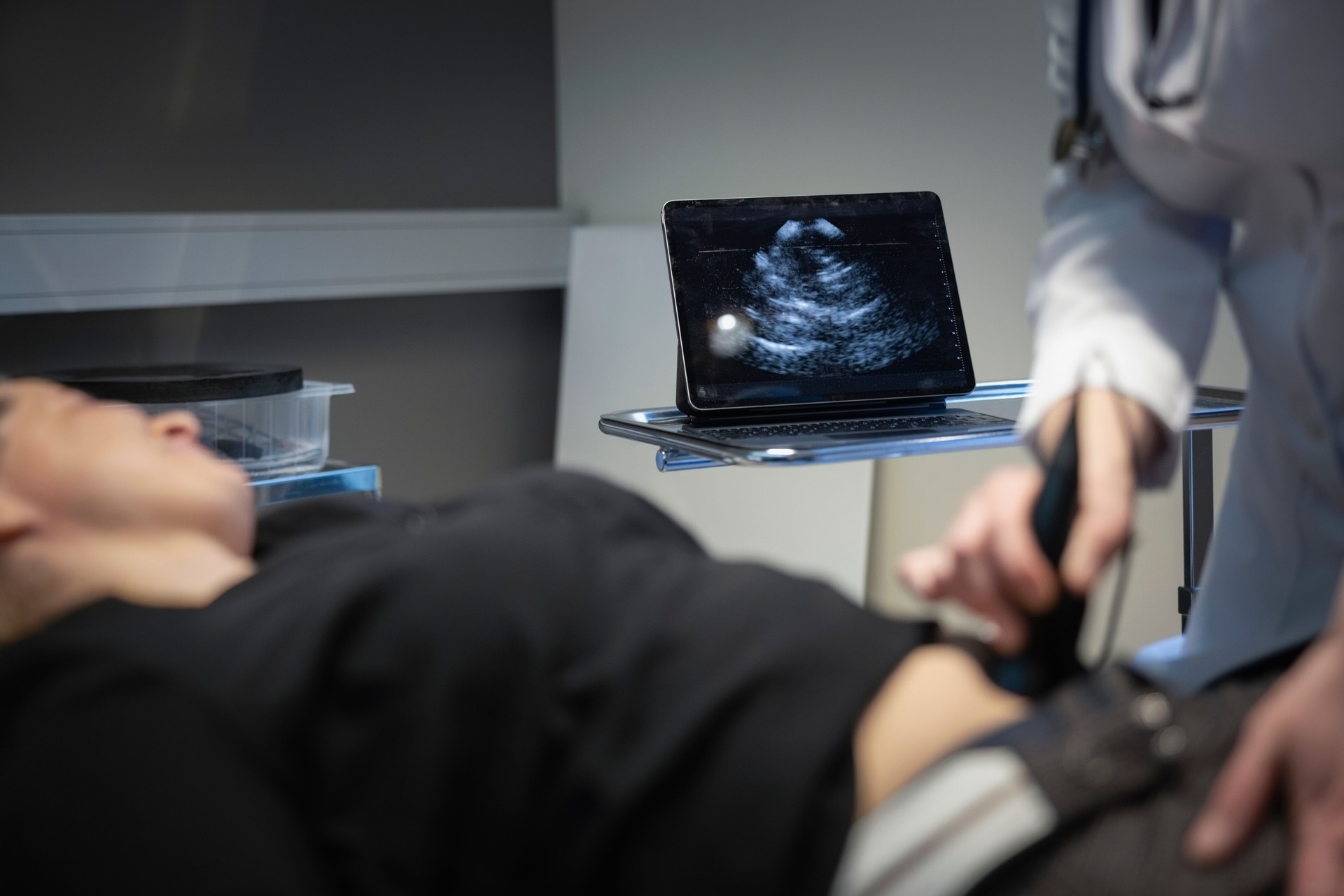 Female doctor using ultrasound scanner to examine patient